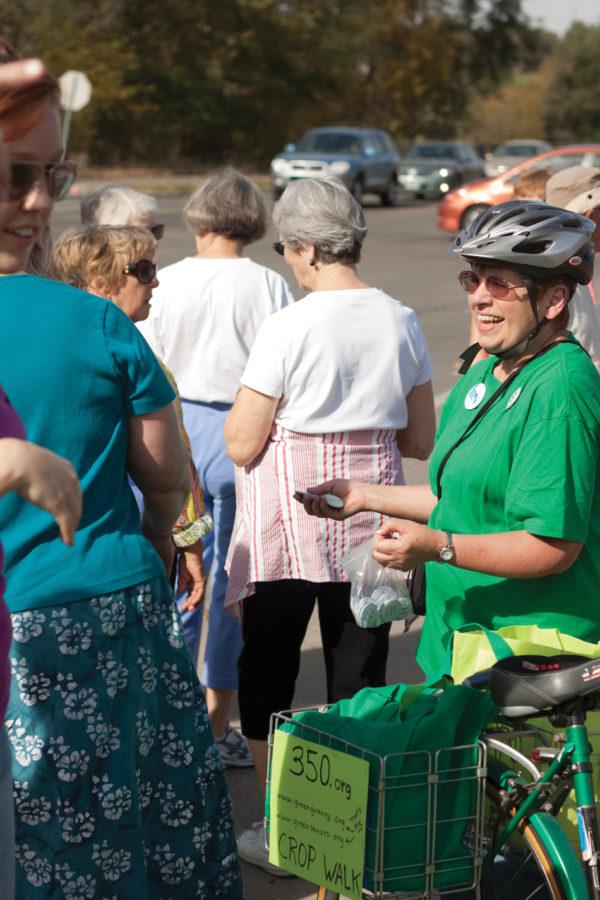 A volunteer for CROP Walk hands out buttons to participating senior citizens on Sunday at the corner of Stange Road and 13th Street. The walk is held annually to raise money to help end hunger and poverty around the world and locally.