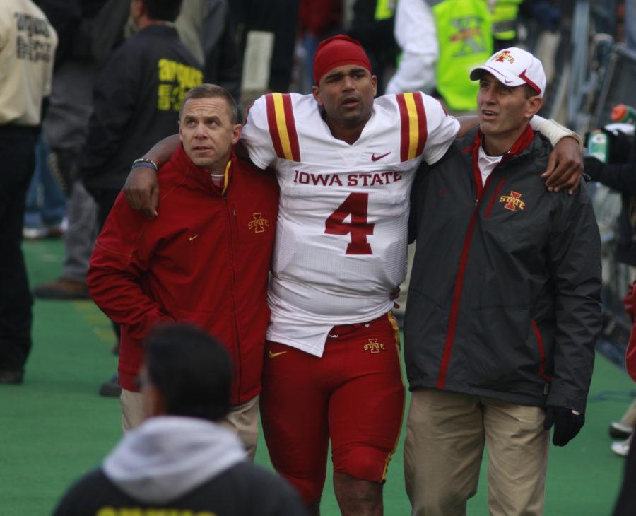 ISU quarterback is helped toward the locker room near the end of Iowa States 34-14 loss to Colorado on Saturday. Arnaud injured his knee during the fourth quarter of the game, and team doctors believe it will keep him out for the remainder of the season.