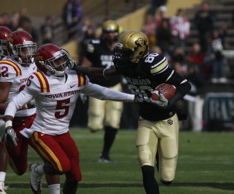 Colorado receiver Paul Richardson tries to avoid ISU defensive back Jeremy Reeves in the first half of Iowa States 34-14 loss to Colorado on Saturday, Nov. 13.