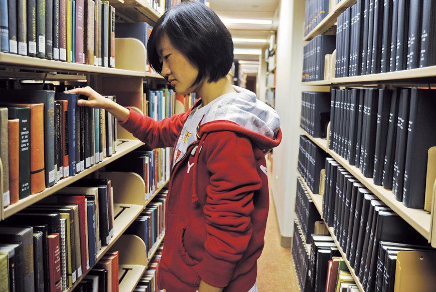 Yini Wang, freshman in bussiness, looks for the book she needs for her upcoming exam at Parks Library.