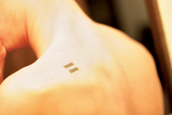 Tyler Parker displays his tattoo, an equal sign.