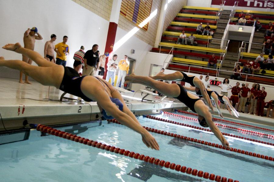 The ISU swimming and diving team take off the starting blocks to take part in the womens 100-yard freestyle competition on Saturday, Oct. 30. Iowa State beat South Dakota State with a score of 152-83, as well as Western Illinois with a score of 161-48.