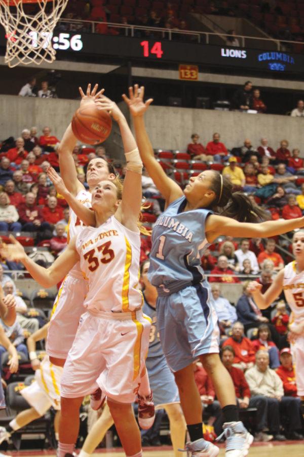 Forward Chelsea Poppens, guard/forward Jessica Schroll and Columbia's Taylor Ward fight for a rebound during the second half of the Iowa State-Columbia game at Hilton Coliseum. Poppens' nine rebounds and Schroll's six rebound helped the Cyclones to defeat the Lions 73-27. 