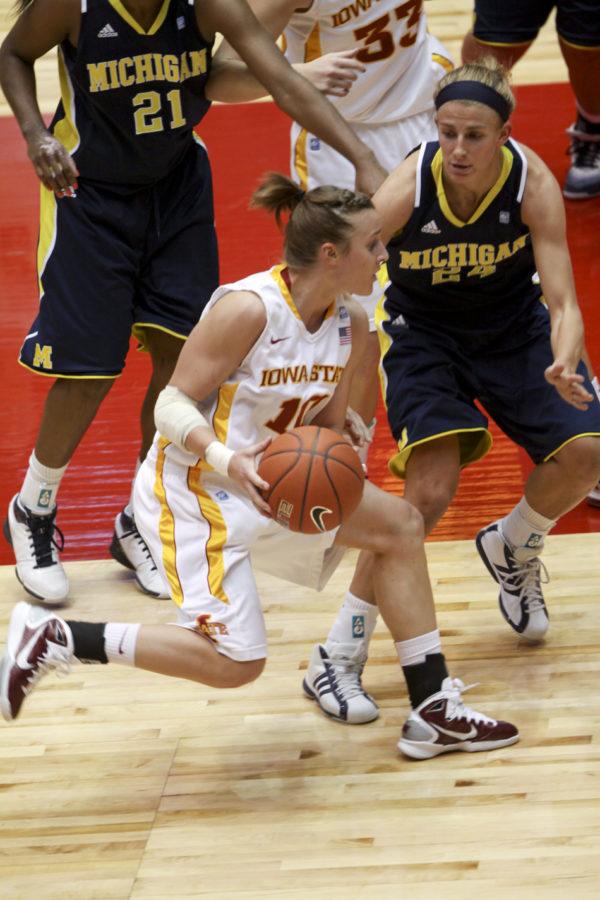 Guard Lauren Mansfield drives the ball around a Michigan opponent during the second half of the game Sunday. Mansfield scored 13 points in the game.