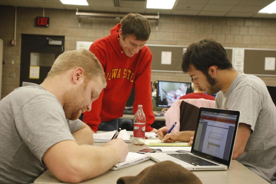 Alex Moraniec, left, Andrew Morse, and Jame Albrecht, seniors in mechanical engineering, spend their Saturday in a computer lab in the Black Engineering Building.