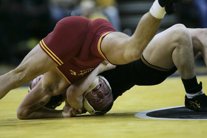 Iowas 174-pounder Ethen Lofthouse holds on to Jon Reader of Iowa State on Friday at Carver-Hawkeye Arena. Lofthouse lost 6-1.
