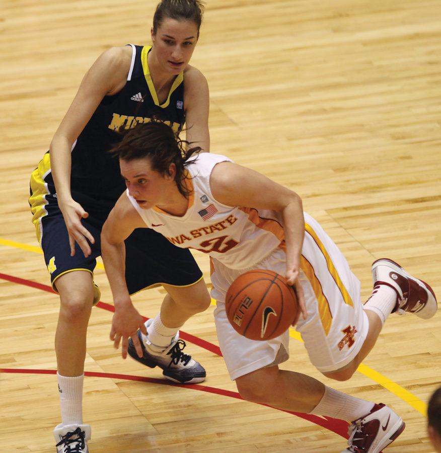 Guard and forward Jessica Schroll rushes past a Michigan opponent during Sundays game at Hilton Coliseum. Schroll had seven rebounds and five points to help the Cyclones defeat Michigan 60-47.