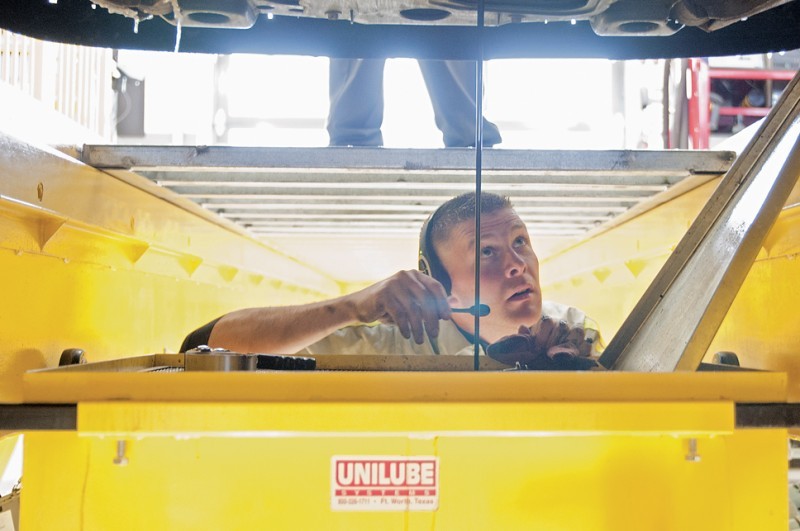 Ben Sage, manager, inspects a vehicle during an oil change Saturday at Lube Oil Filter Xpress, 520 S. Duff. LOF-Xpress opened Nov. 15 and has been exceeding its expected number of cars per day. Customers can watch their oil change being performed and are offered coffee or tea while they wait.