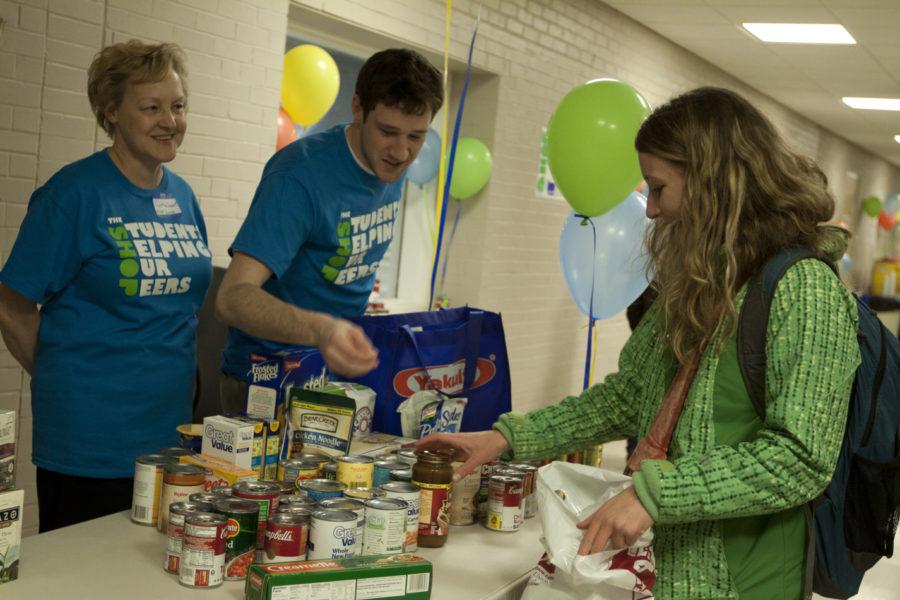 Cassidi Thompson, senior in anthropology, donates food to The Shop on Thursday in Food Sciences building.
