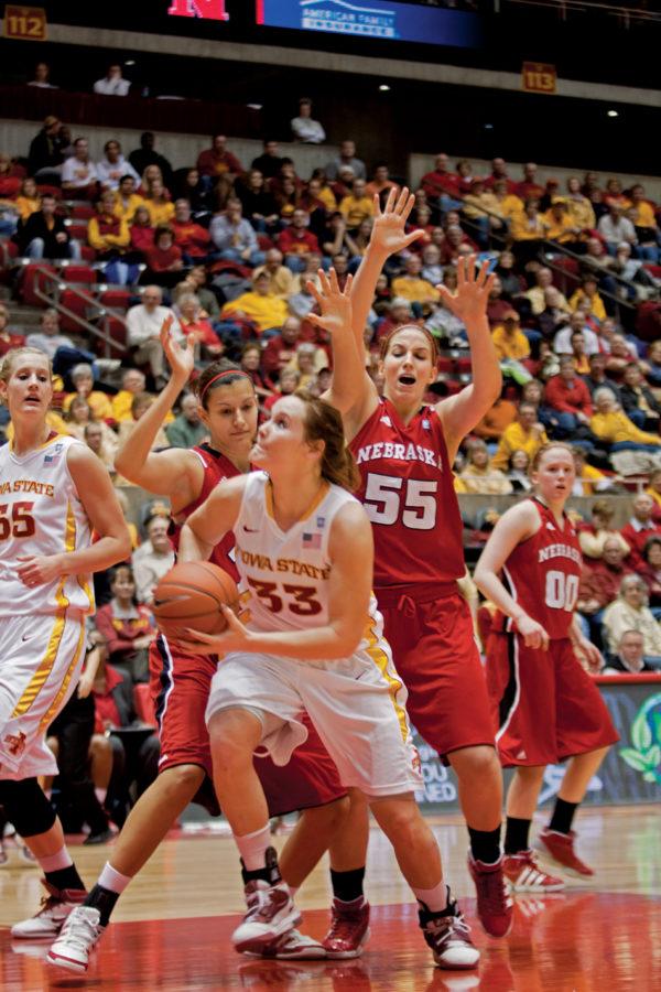 Forward+Chelsea+Poppens+looks+to+shoot+the+ball+over+Nebraska+opponents+during+Tuesdays+game+at+Hilton+Coliseum.+Poppens+had+6+rebounds+and+7+points+to+help+the+Cyclones+defeat+the+Huskers+64-43.