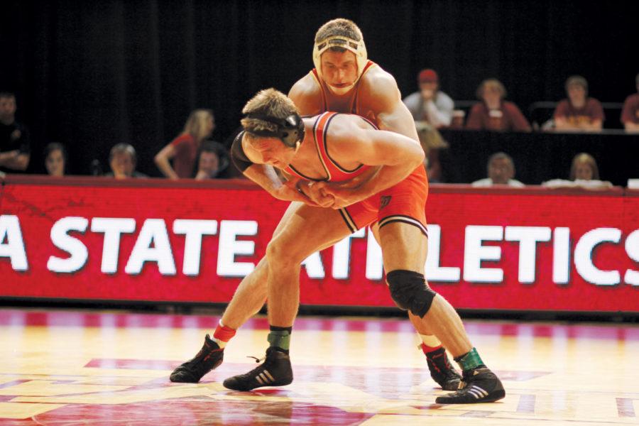 Andrew Sorenson prepares to flip Oklahoma States Dallas Bailey to the mat during the match on Sunday at Hilton Coliseum. Sorenson defeated Bailey 5-3 while the Cyclones lost to the Cowboys 13-29.