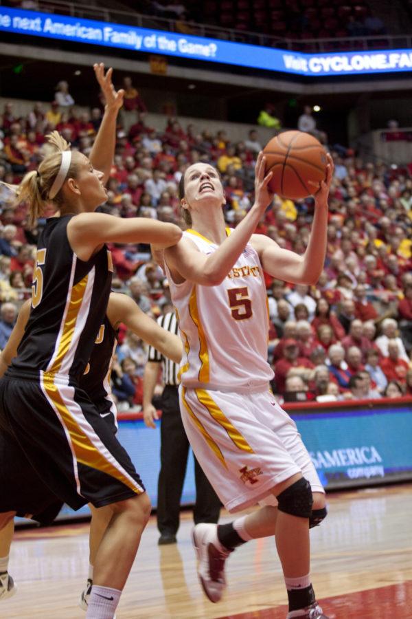 Forward Hallie Christofferson moves the ball around a Mizzou opponent in order to make a shot during the game against Missouri on Saturday at Hilton Coliseum. Christofferson lead the team in scoring with a score of 18 points.