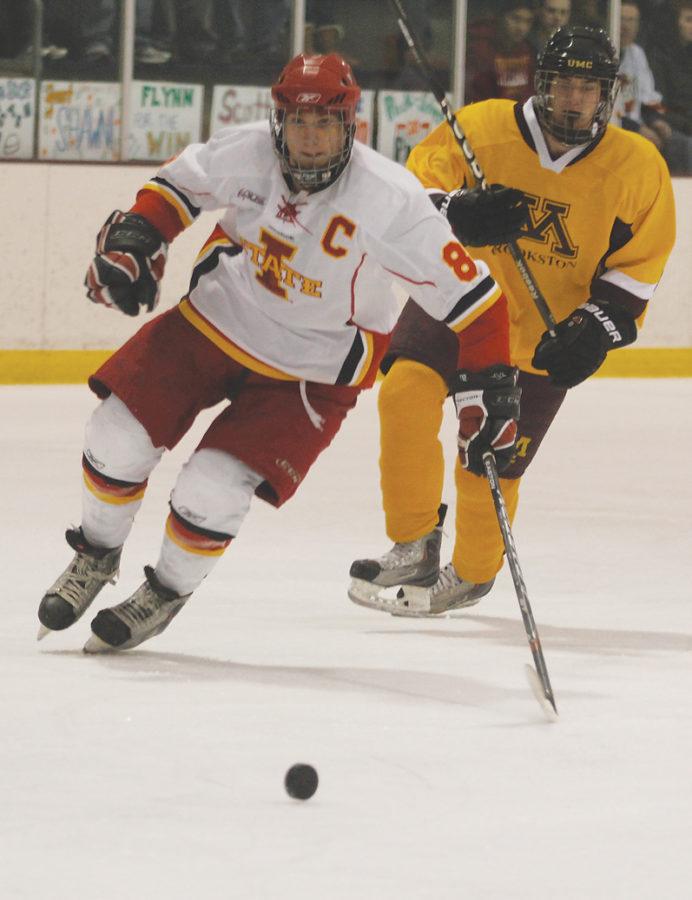 Forward Cort Bulloch chases after the puck during the game against Minnesota Crookston on Friday, Jan. 21 at the Ames/ISU Ice Arena.