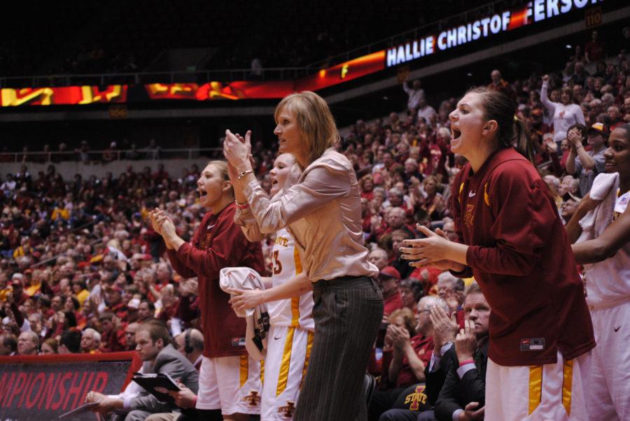 ISU guard Kelsey Harris, right, assistant coach Jodi Steyer, forward Chelsea Poppens and Amanda Zimmerman, celebrate after an ISU score in the Cyclones 71-56 win over Missouri on Saturday, Jan. 29 at Hilton Coliseum. 