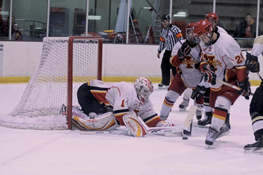Goalie Erik Hudson and a few of his teammates stop an attempted goal by a Lindenwood opponent during the match Friday, Dec. 3, at the Ames/ISU Ice Arena. The Cyclones fell to the Lions 4-2.