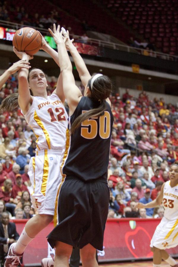 Guard Jessica Schroll goes up for a shot against a Mizzou opponent during the Iowa State-Missouri game Saturday.The Mizzou Tigers lost to the Cyclones with a final score of 71-56.