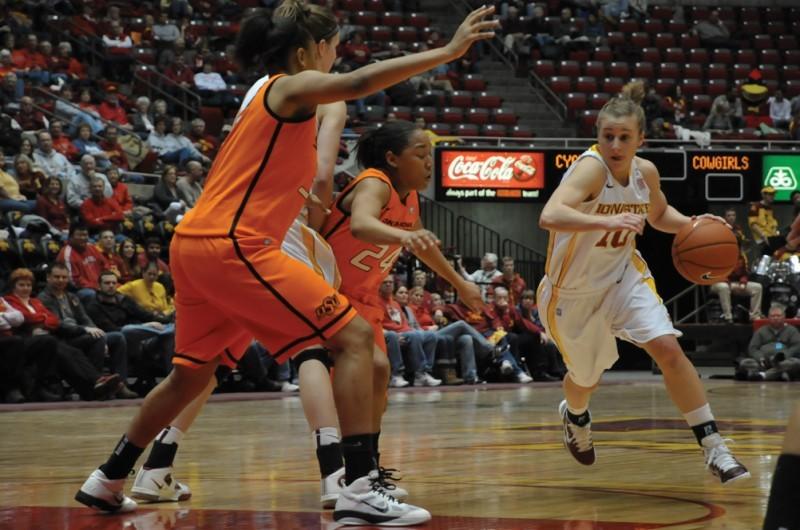 Guard Lauren Mansfield dribbles down the court and attempts to pass by Oklahoma State players on Wednesday, Feb. 2 at Hilton Coliseum. 