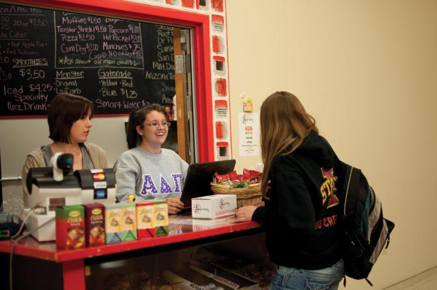 Caytlin Hentzel, sophomore in event management, and Stephanie Curtis, sophomore in hotel, restaurant, and institution management, talk to Cassandra Hinz, junior in biology at the Barista Cafe located in Buchanan Hall.