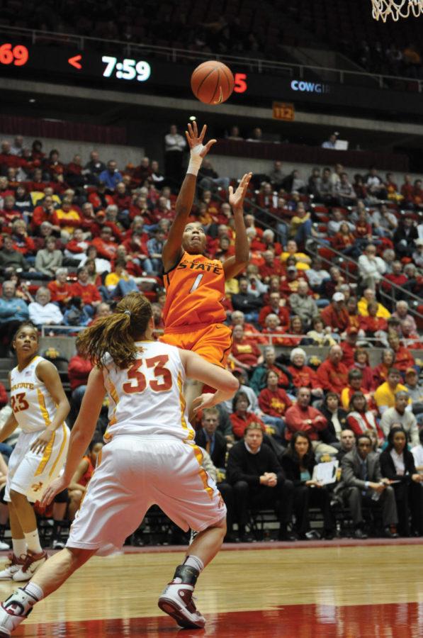 Oklahoma States Precious Robinson attempts to make a shot over Cyclone front Chelsea Poppens during the Iowa State-Oklahoma State game Wednesday, Feb. 2 at Hilton Coliseum.The Cyclones defeated the Cowgirls 79-59. 