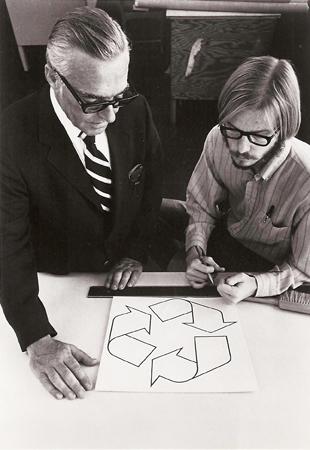 Gary Anderson, left, and an executive from the Container Corporation of America review the recycling symbol. Anderson designed the recycling symbol and was the winner of the contest in 1970. Anderson is a judge for the Cereplast contest. The other man is an executive from Container Corporation of America who launched the 1970 contest.