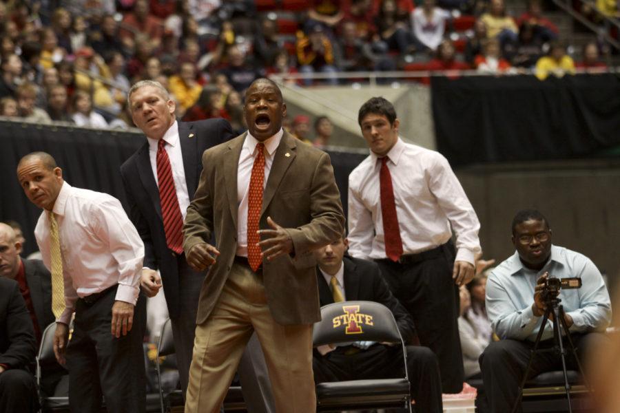 Head coach Kevin Jackson cheers on the wrestling team during the Beauty and the Beast competition Friday. Iowa State fell to Oklahoma with a score of 33-7.