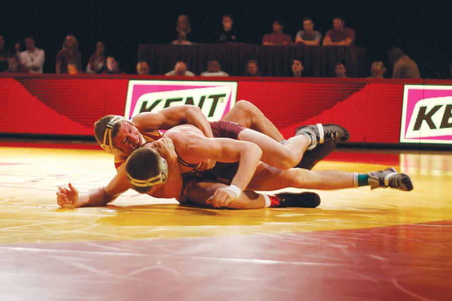 Jon Reader fights to flip Arizona State opponent Jake Meredith during the wrestling meet Sunday, Feb. 6 at Hilton Coliseum. Reader defeated Meredith 14-3.