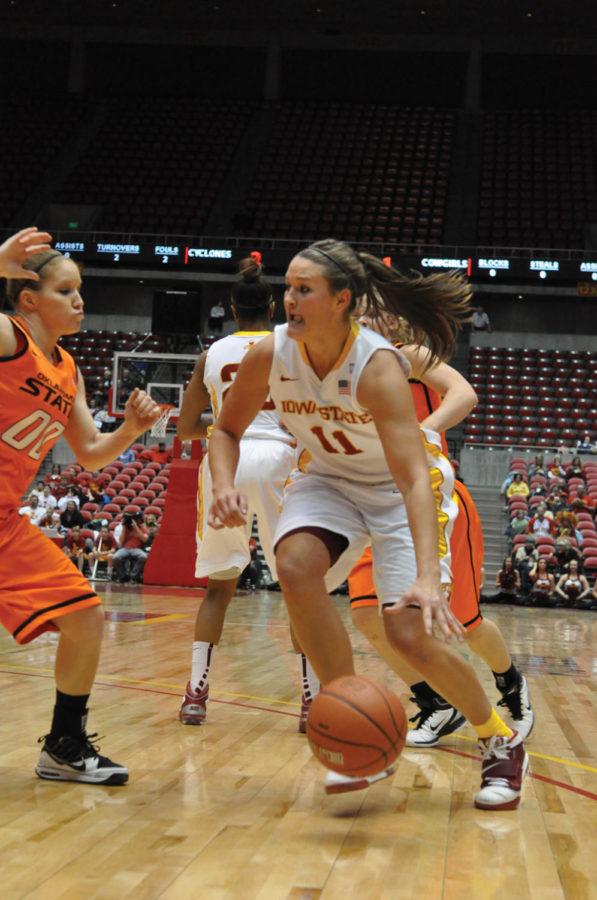 Cyclone guard Kelsey Bolte attempts to pass the Oklahoma State Lakyn Garrison during the Iowa State - Oklahoma State game Wednesday, Feb. 2 at Hilton Coliseum. The Cyclones defeated the Cowgirls 79-59.