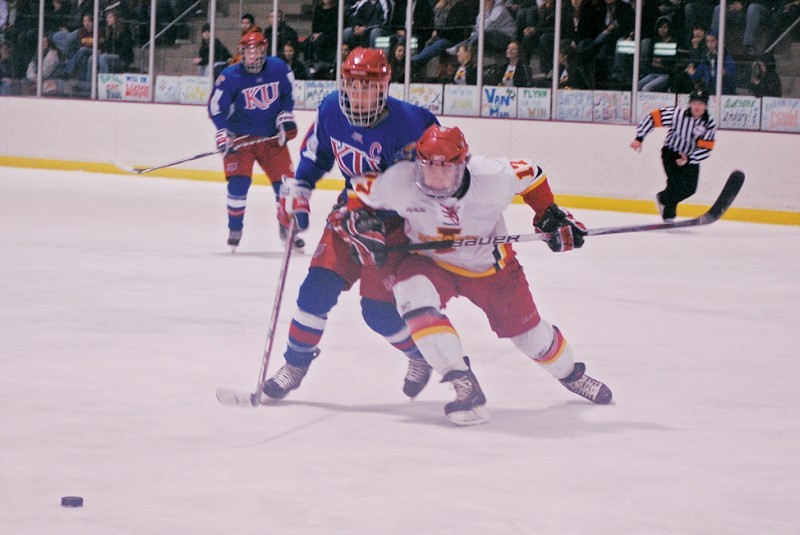Forward Marcus Malmsten fights to gain the puck during the Iowa State - Kansas match Friday, Feb. 4 at the Ames/ISU Ice Arena. The team is preparing for the Central States Collegiate Hockey League Tournament this weekend in Bensenville, Illinois.