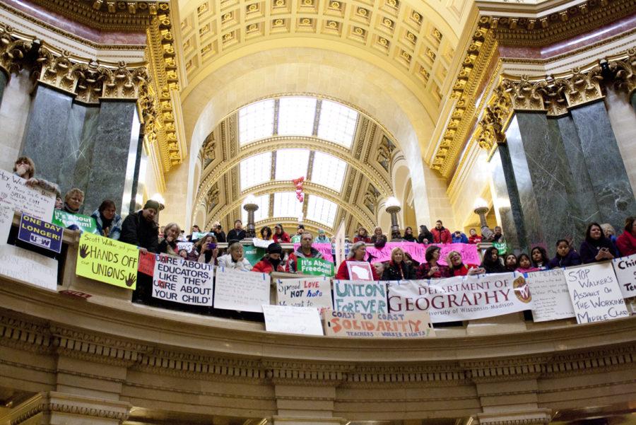 Signs cover the walls and balconies inside the Wisconsin Capitol Building this week. Each one represents a different voice in the protests. 