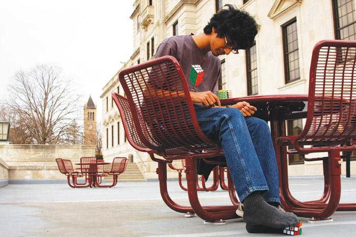 Rohan Sharma, freshman in aerospace engineering, plays with his Rubiks cube Thursday, March 31, outside the Memorial Union. Sharma has the ability to solve a Rubiks cube with not only his hands, but also his feet.