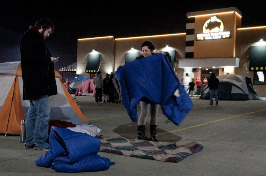 Lilly Pavlou, senior in mechanical engineering and Russian, and Terry Crooks, of Ames, set up sleeping bags Sunday for their stay outside of Buffalo Wild Wings. Pavlou and Crooks had been waiting since 8:30 p.m. and had known about the contest for awhile before suddenly deciding to participate.