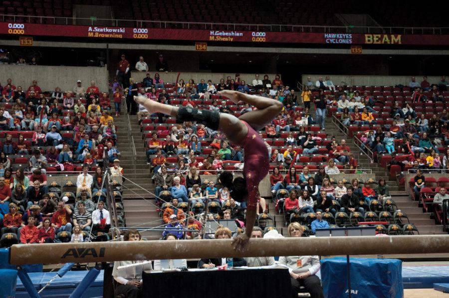 Jacquelyn Holmes performs her beam routine during the meet against the University of Iowa on Friday at Hilton Coliseum. The Cyclones defeated the Hawkeyes 196.350 - 195.850 