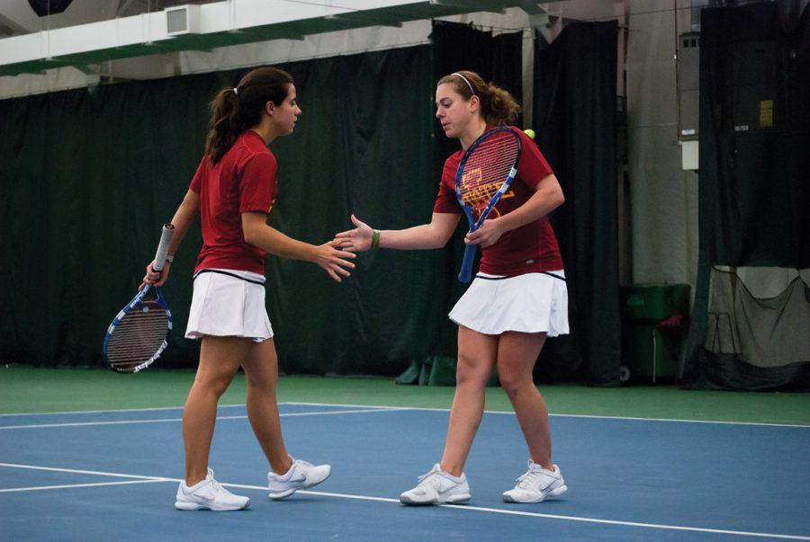 Iowa State doubles team, Simona Cacciuttolo and Erin Karonis, congratulate each other after scoring during a match against UNI at Ames Raquet and Fitness Feb. 25. Cacciuttolo and Karonis lost to UNIs Jessica Kunzelmann and Krissy Lankelma 7-8 (8-2).