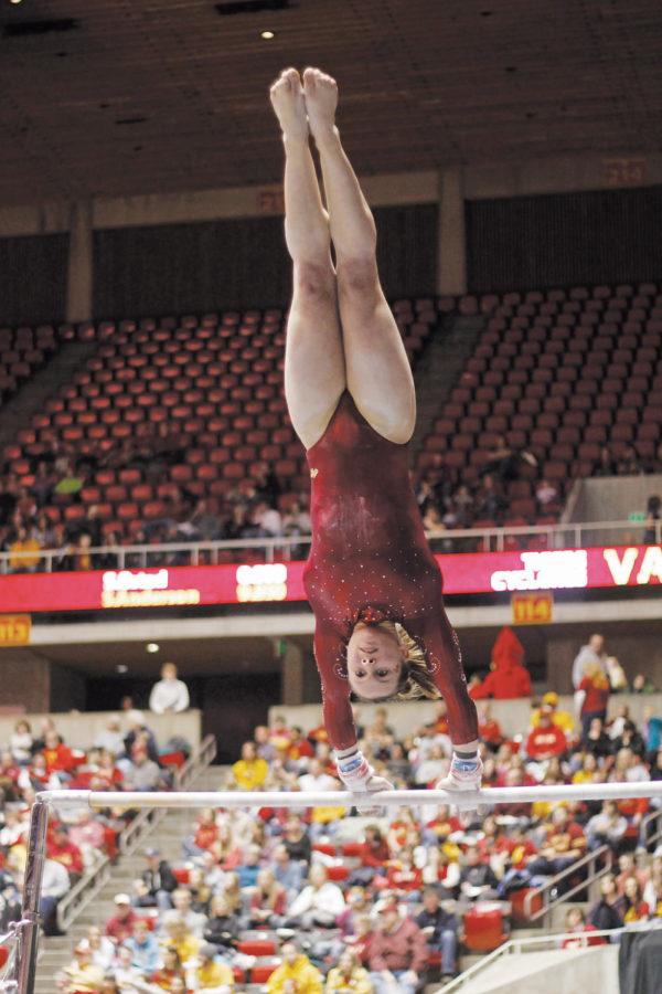 Jody McKellar participates in the uneven bars during the Beauty and the Beast event held Jan. 21 at Hilton Coliseum. 