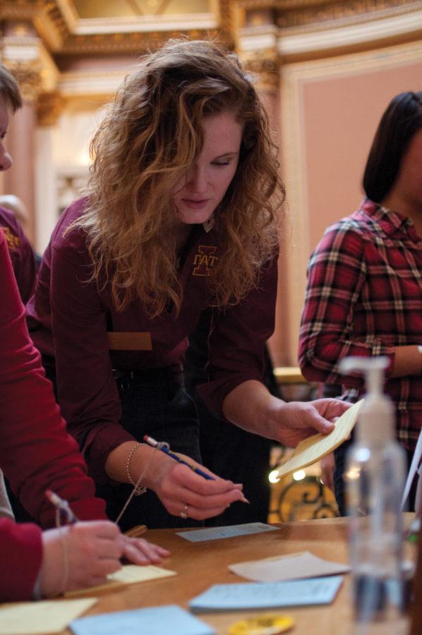 Ahna Kruzic, junior in sociology and Iowa State Daily columnist, fills out a form to meet with one of the representatives from the education committee Monday at the Iowa State Capitol.