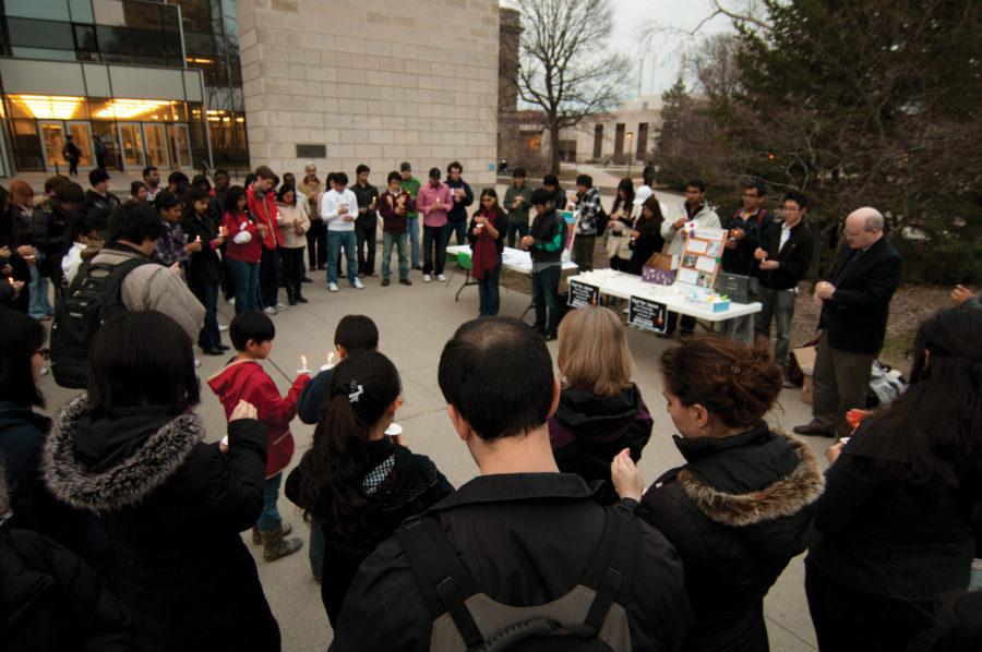 Students, staff and members of the Ames community take part in a candlelight vigil for the victims of Japans recent catastrophes Thursday, March 31, outside Parks Library.

