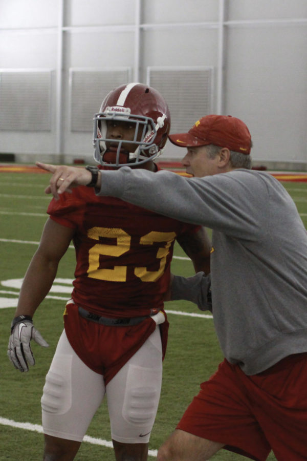 Iowa State cornerback Leonard Johnson listens to directions from coach Paul Rhoads. Spring football practice started March 22, at the Bergstrom Practice Facility.