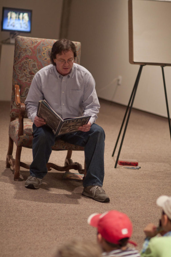 Associate professor of design Chuck Richards entertains the crowd with one of his two books Jungle Gym Jitters. After the readings the children who attended were allowed to partake in a scavenger hunt on Sunday, April 10 at the Brunnier Art Museum.