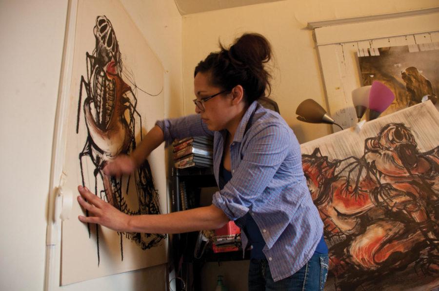 Renelle White Buffalo, senior in integrated studio arts, works on her drawings at her apartment. She said her art is influenced by her mother, as her mother had a monster just like everyone else, and alcohol fueled her monster and it eventually took over.
