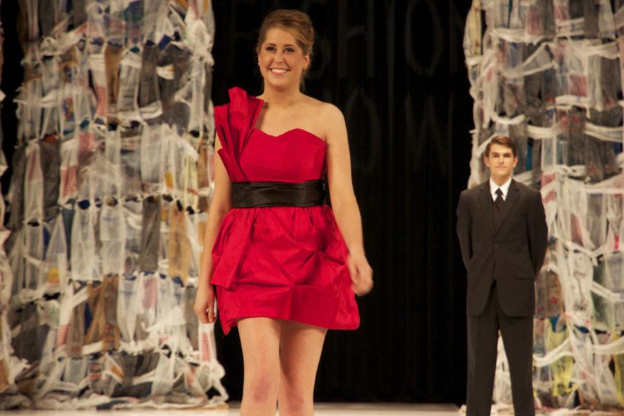 A+model+wears+a+red+dress+fashioned+by+Chelsey+Stoner%2C+senior+in+apparel+design%2C+in+Stephens+Auditorium+on+Saturday+during+the+fashion+show.+%0A%0A%5BThis+cutline+has+been+updated+from+its+original+version.%5D