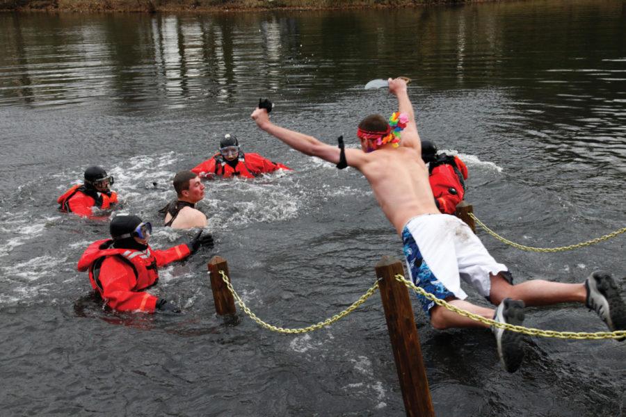 Ethan Wise supermans it at the Polar Plunge. Over $45,000 was raised for the special olympics as more than 800 people slipped, jumped, dove, and flopped into the fresh waters of Lake Laverne. Photo: Clark Colby/Iowa State Daily