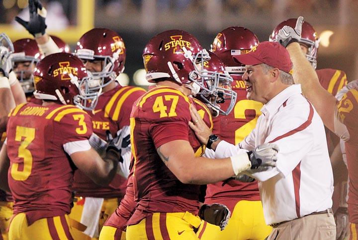 Coach Paul Rhoads congratulates A.J. Klein, 47, during Saturdays game against Texas Tech. The Cyclones won the game with a final score of 52-38.