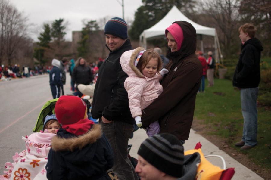 Aaron and Jessica Catlin, with their daughters, Ezri and Tovah, wait for the VEISHEA parade to begin, Saturday, April 16, south of Campanile. 