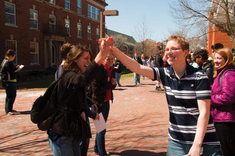 Mary Hallman, left, sophomore in economics, gets a high-five from Amy Boitnott, senior in psychology, after a correct guess. Boitnott is president of the LGBTA, who hosted a lineup at noon on Tuesday, April 5 outside the Student Services Building.
