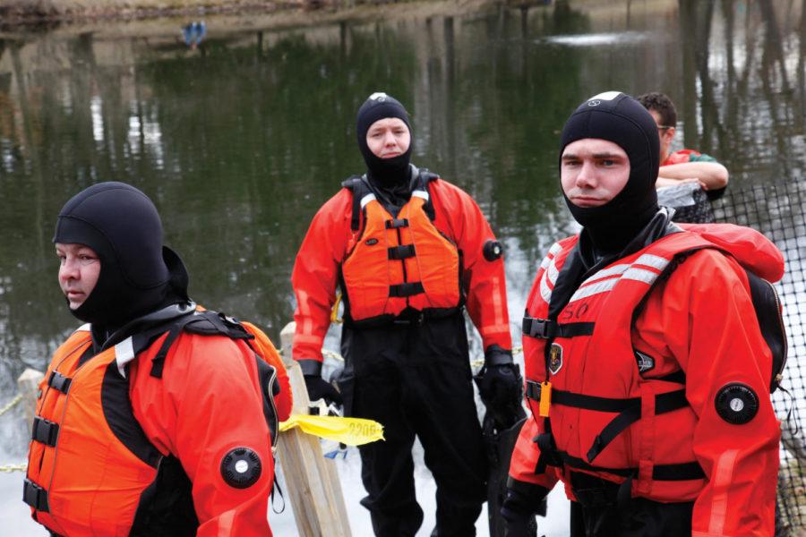 Rescue workers suit up to join in the fun for precautionary measures.  Over $45,000 was raised for the special olympics as more than 800 people slipped, jumped, dove, and flopped into the fresh waters of Lake Laverne. Photo: Clark Colby/Iowa State Daily