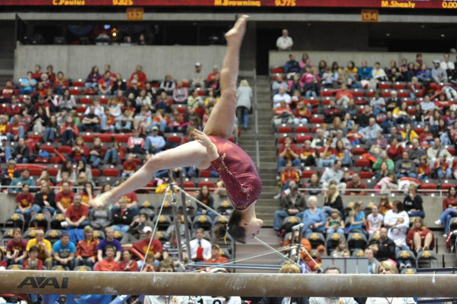 Michelle Shealy performs an aerial trick in her beam routine during the meet against the University of Iowa on Friday at Hilton Coliseum. The Cyclones defeated the Hawkeyes 196.350 - 195.850.