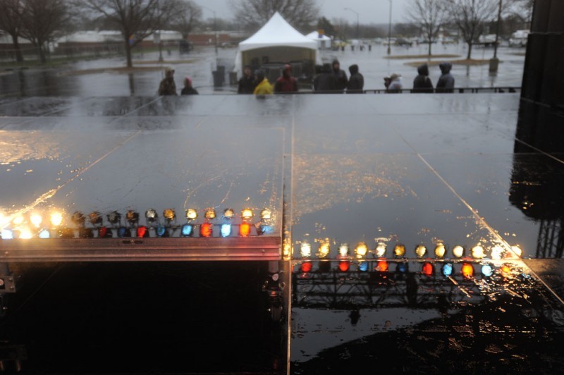The stage lights reflect on wet pavement. Live @ VEISHEA was canceled because of rain and high wind.