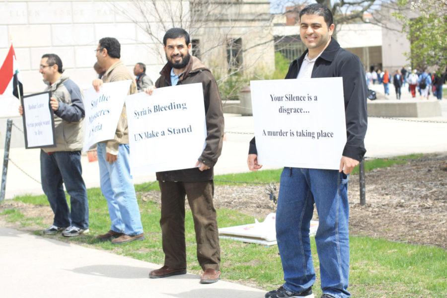 Ramzi Saifan, right, and Naeem Al-Oudat, both graduate students in electrical and computer engineering, protest Thursday in the Free Speech Zone.  