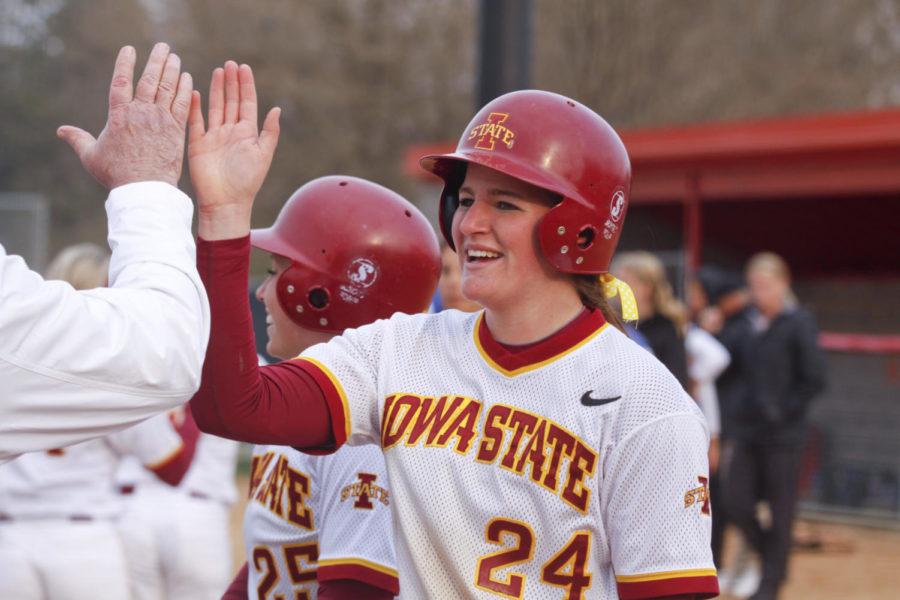 Infielder Tori Torrescano is greeted by high-fives and hugs after her game-winning home run in the seventh inning. The Cyclones won with a score of 8-6.