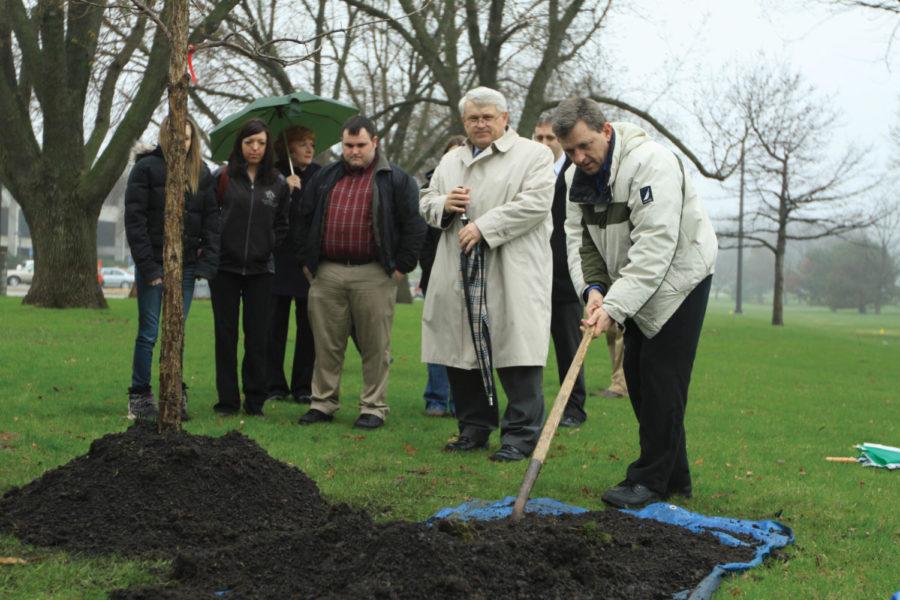 Steve Danielson plants a tree in memory of son Tyler Danielson on Friday, April 22 north of the Hilton Coliseum. 